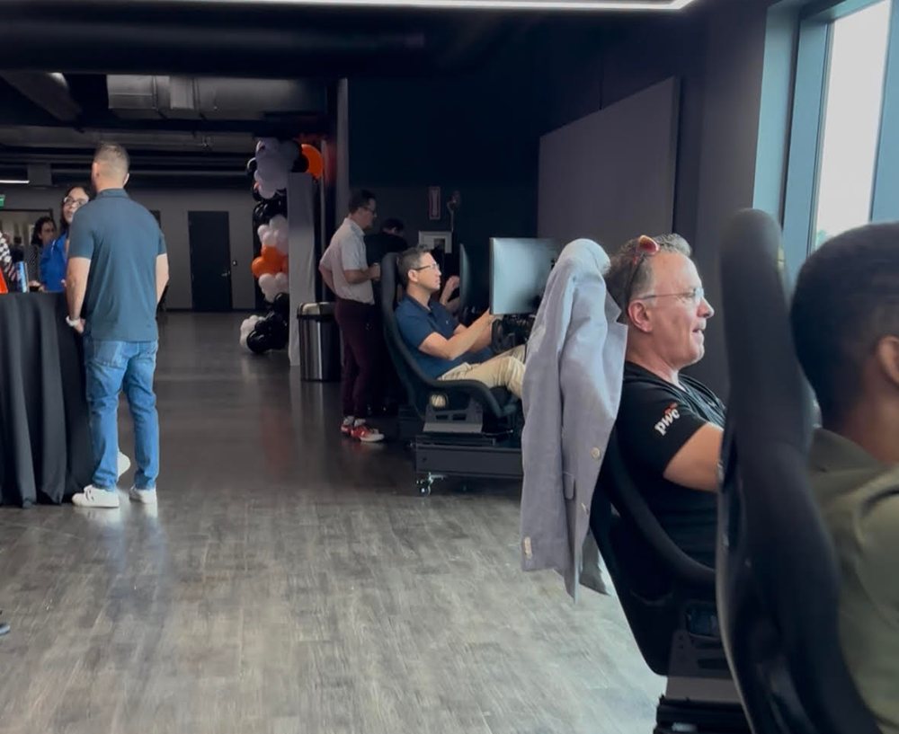 Corporate guests racing simulators at a PwC event