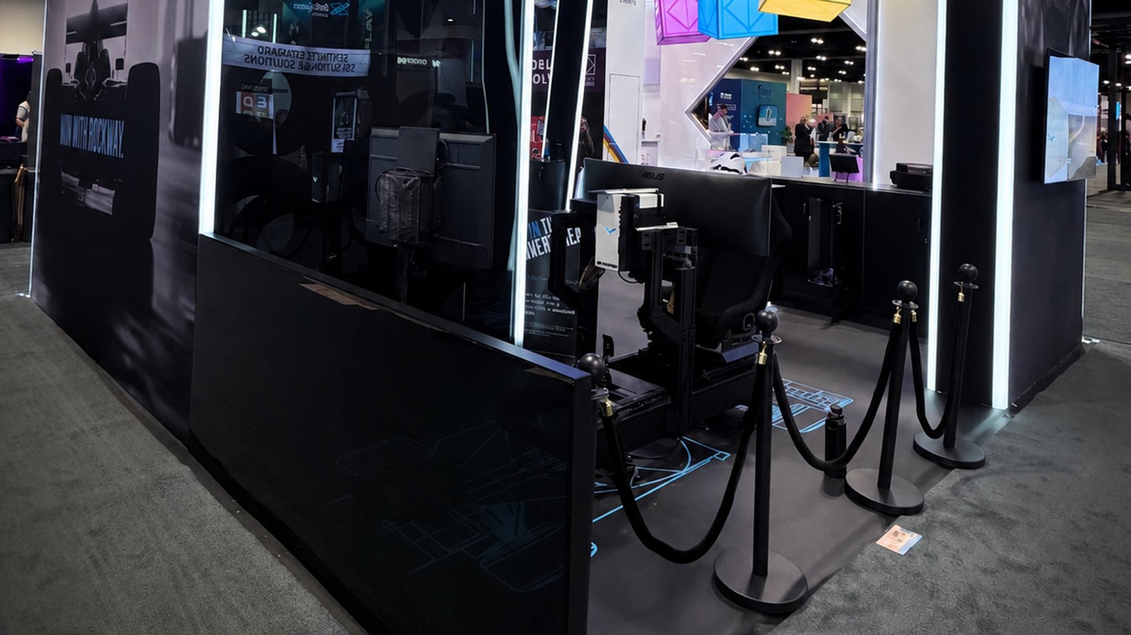 Academy Sim Racing branded simulator activation at a trade show exhibit