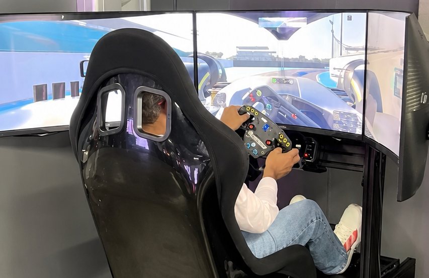 Guest racing on a genuine triple-screen professional simulator at an event